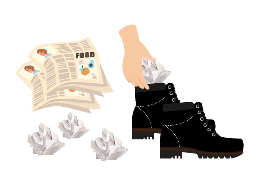 stuffing newspaper into a pair of boots
