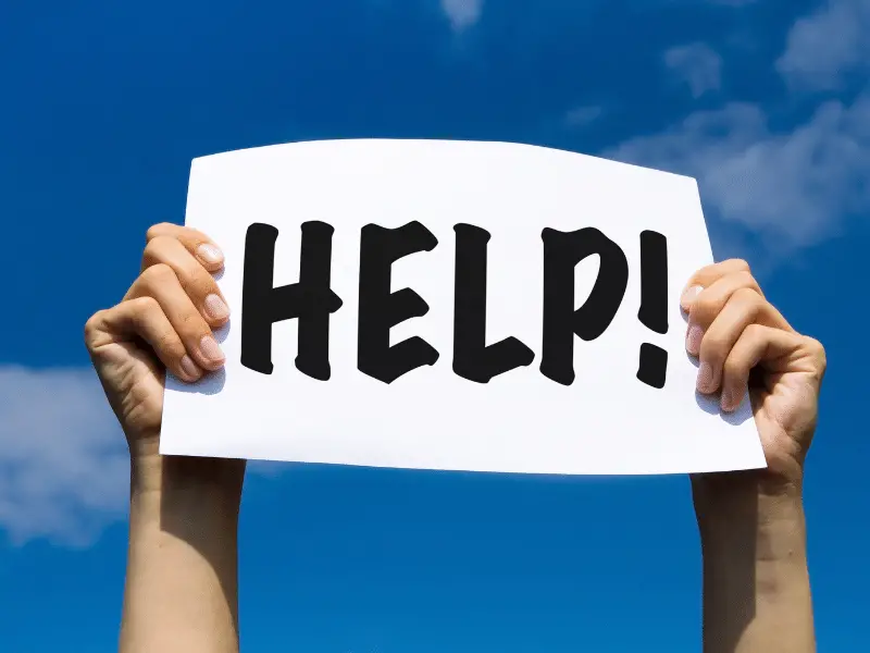 Person holding up a help sign